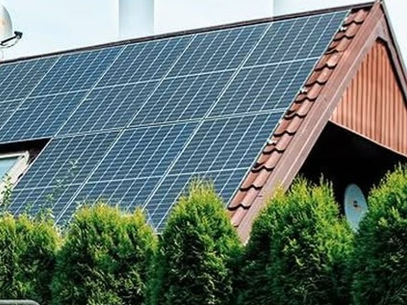 Solar panels covering the tiled roof of a family home